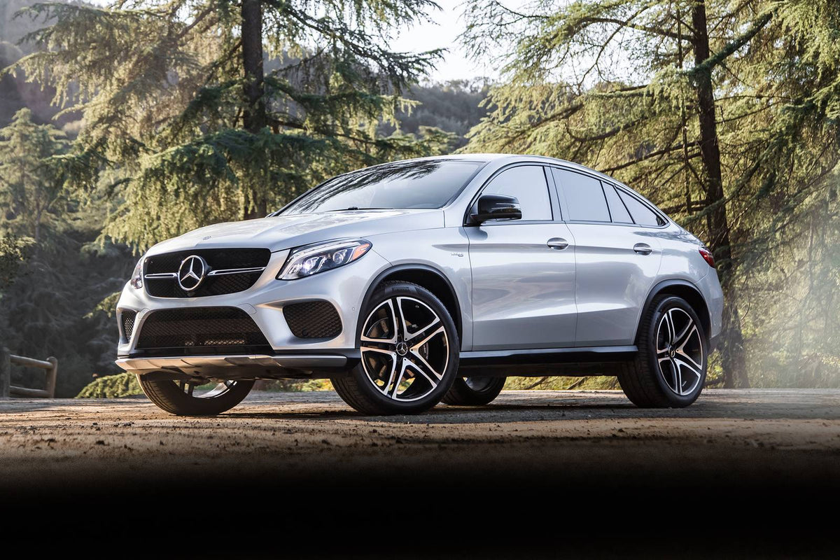 Silver Mercedes-AMG GLE 43 Coupe parked among pine trees