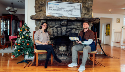 Kaitlin M. holding her $100,000 check